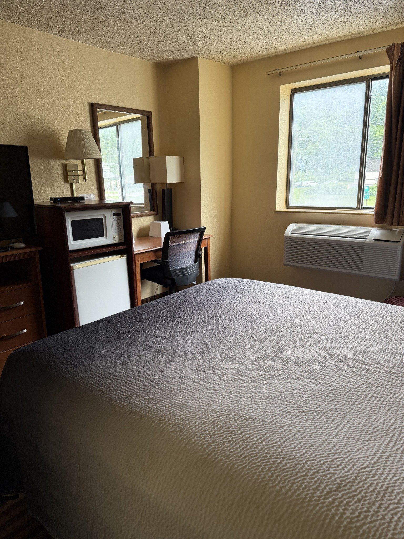 Guest room with desk and television